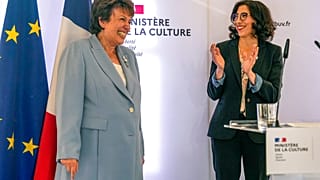 French Culture Minister Roselyne Bachelot, left, smiles as newly named French Culture Minister Rima Abdul-Malak