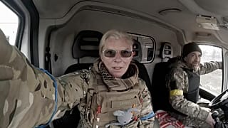 Yuliia Paievska, known as Taira, and her driver Serhiy sit in a vehicle in Mariupol, Ukraine on March 9, 2022.