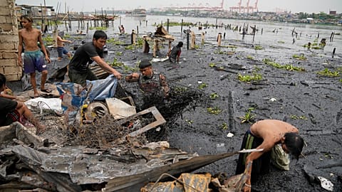 Residents inspect damage after huge fire in Manila