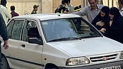 Angehörige von Hassan Sayyad Khodaei stehen neben dem Fahrzeug des hochrangigen Offiziers der Revolutionsgarden kurz nach dessen Mord in Teheran am Sonntag, 22. Mai 2022
