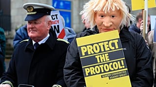 Demonstrators protest outside Hillsborough Castle, ahead of a visit by British Prime Minister Boris Johnson, in Hillsborough, Northern Ireland, Monday, May, 16, 2022.