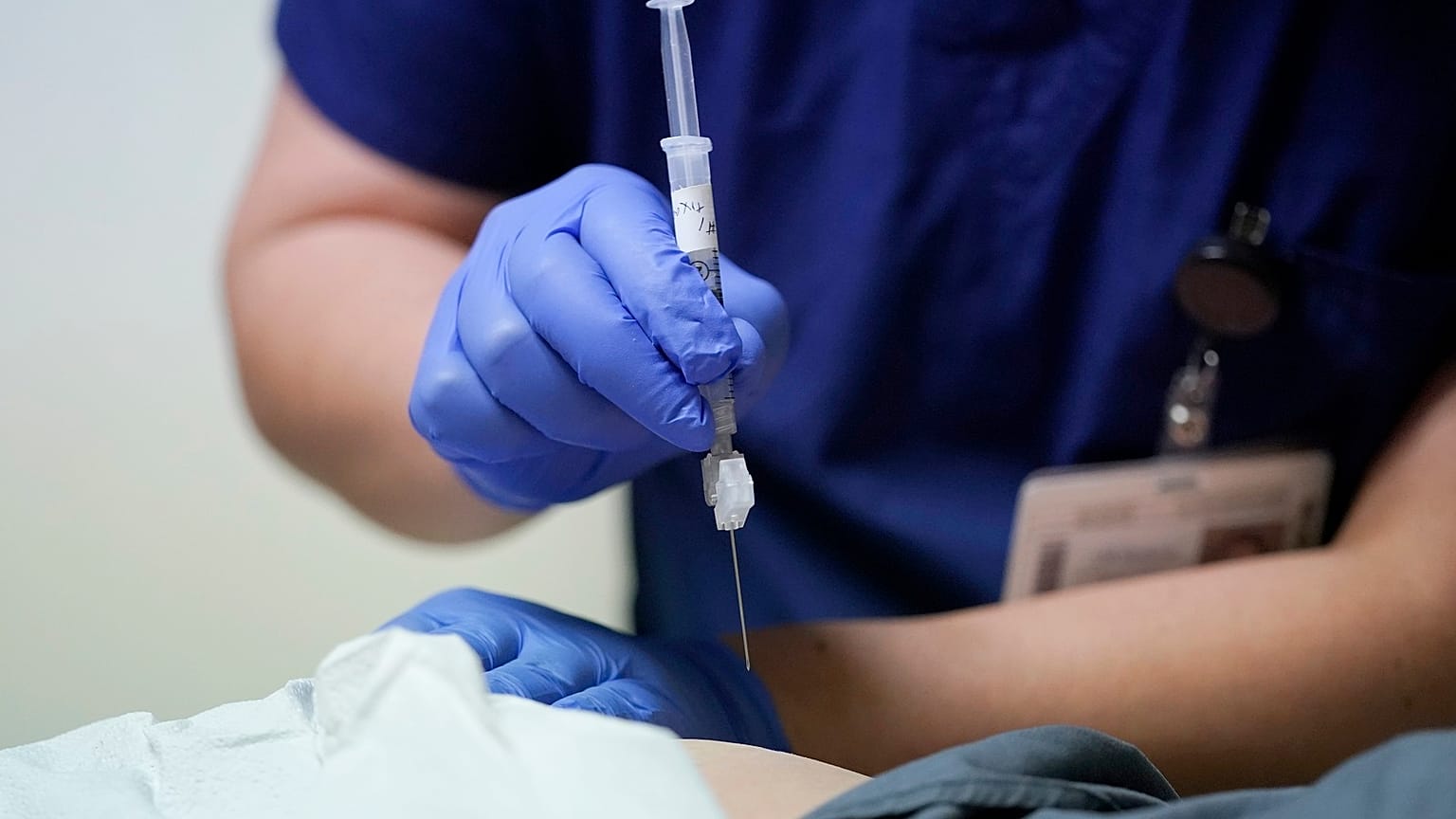 Ray Hoffman, who is immune-compromised, is given a shot of the two-shot dose of AstraZeneca's Evusheld — the first set of antibodies grown in a lab to prevent COVID-19.