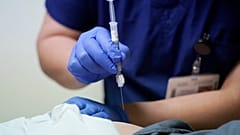 Ray Hoffman, who is immune-compromised, is given a shot of the two-shot dose of AstraZeneca's Evusheld — the first set of antibodies grown in a lab to prevent COVID-19.