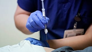 Ray Hoffman, who is immune-compromised, is given a shot of the two-shot dose of AstraZeneca's Evusheld — the first set of antibodies grown in a lab to prevent COVID-19.