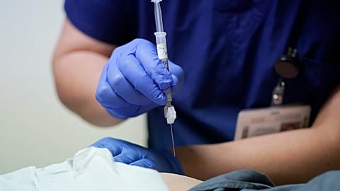 Ray Hoffman, who is immune-compromised, is given a shot of the two-shot dose of AstraZeneca's Evusheld — the first set of antibodies grown in a lab to prevent COVID-19.