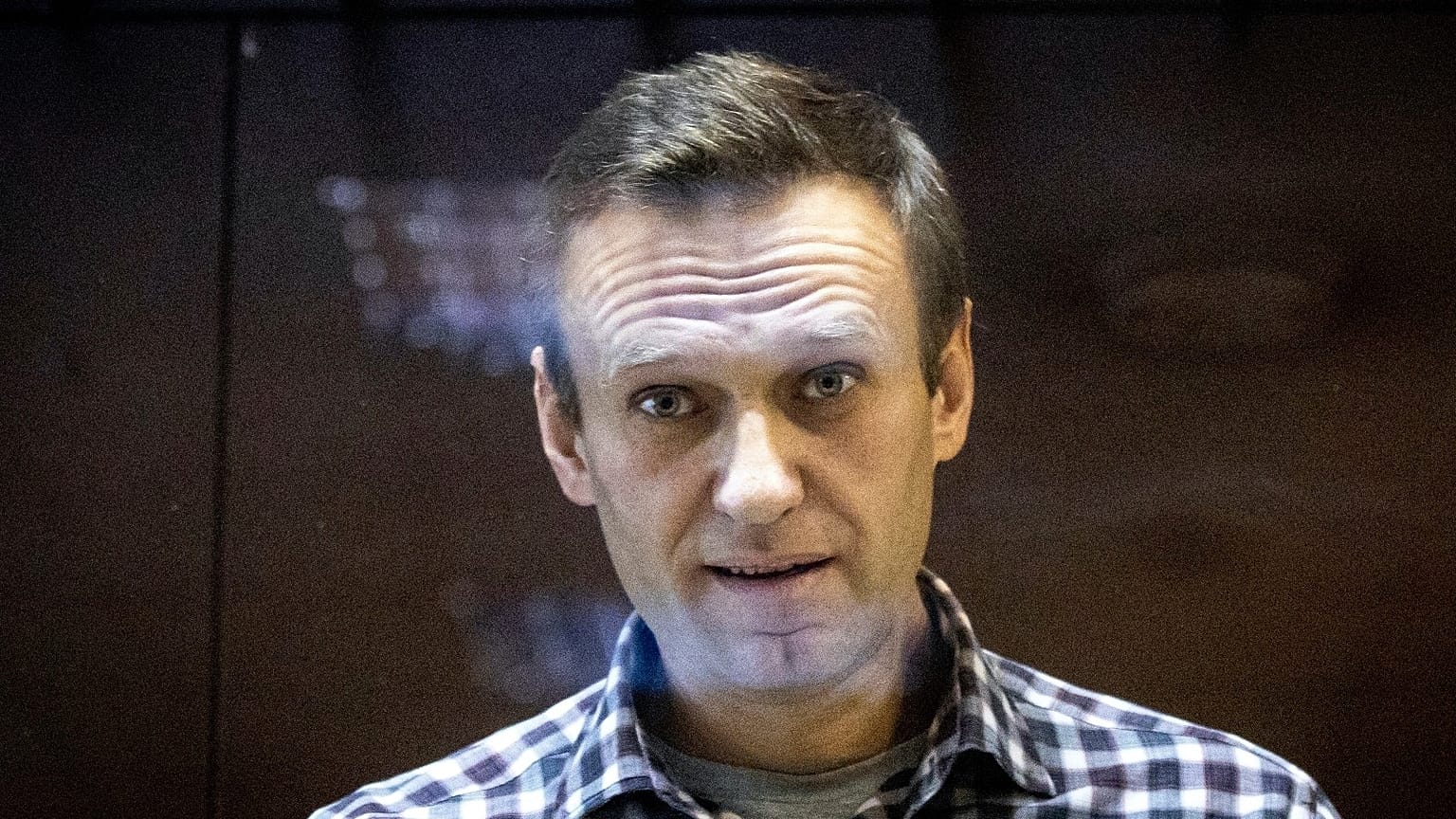  Russian opposition leader Alexei Navalny looks at photographers standing in the Babuskinsky District Court in Moscow, Russia, Saturday, Feb. 20, 2021. FILE