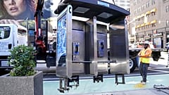Workers remove the final New York City payphone in Midtown Manhattan