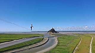 Nathan Paulin walks 2.2km along a tightrope to Mont Saint-Michel