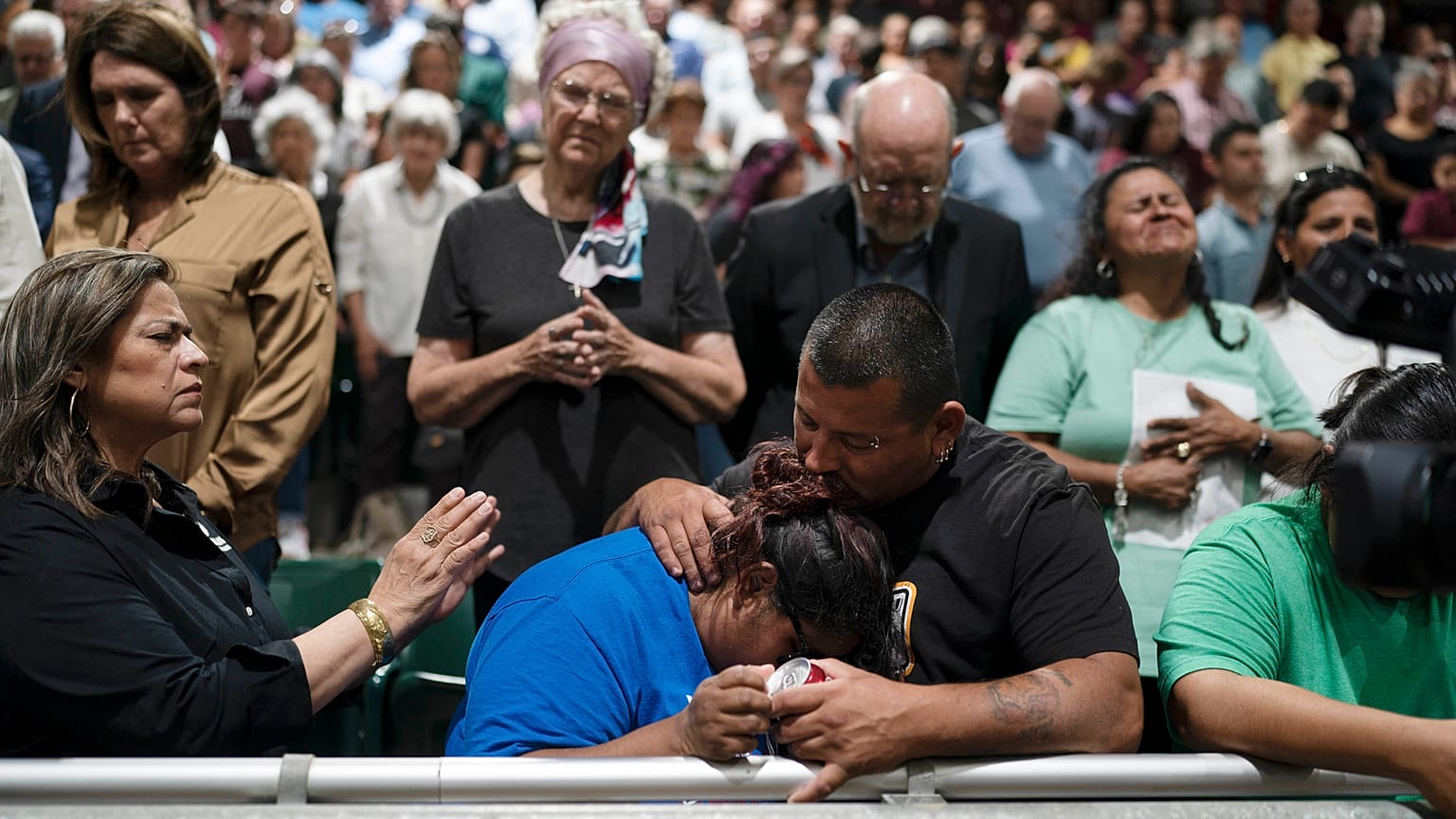 Two family members of one of the victims killed comfort each other during a prayer vigil.