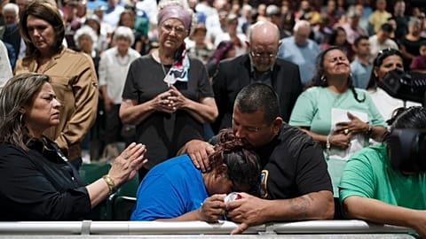 Two family members of one of the victims killed comfort each other during a prayer vigil.