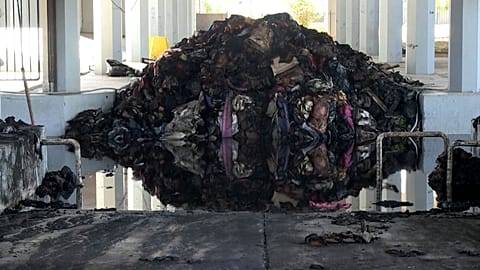 A pile of destroyed bed linen and blankets, sits in a pool of water following a fire at the Peace and Friendship Stadium, in the Piraeus district of Athens, on May, 26, 2022.