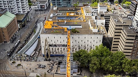 Visitors walk across the sky bridge that was built for the Rotterdam Rooftop Walk in Rotterdam,