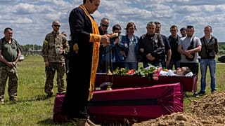 Relatives and friends attend the funeral of Ukrainian serviceman Vitaliy Nejenits in Kharkiv cemetery, eastern Ukraine, Friday, May 27, 2022.