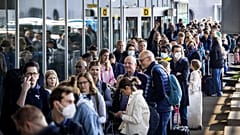 Travellers queue outside a departure hall at Schiphol airport during recent strikes. 