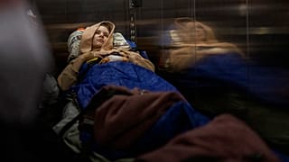Nastia Kuzik, 21, is carried on a stretcher in a lift while being transported by a medical team to Germany, at a public hospital in Kyiv on 5 May 2022