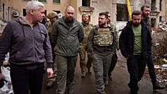 الرئيس الأوكراني فولوديمير زيلينسكي (يمين الوسط) يتحدث مع المسؤولين المحليين أثناء زيارته لمنطقة خاركيف المنكوبة، 29 مايو 2022