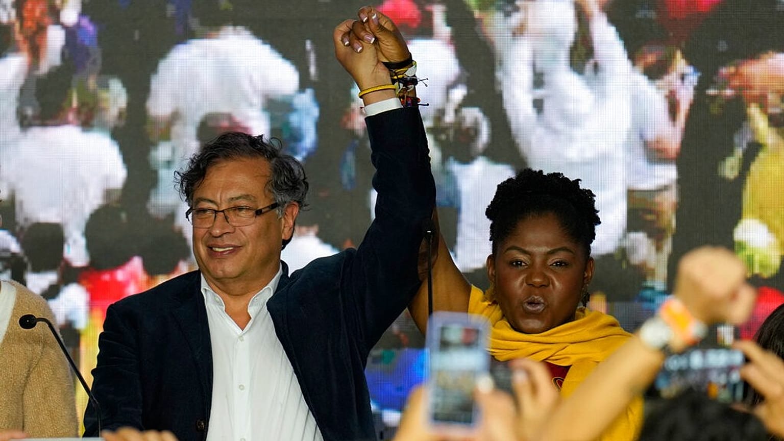 Presidential candidate Gustavo Petro, left, and his running mate Francia Marquez stand before supporters on election night in Bogota, Colombia, Sunday, May 29, 2022. 