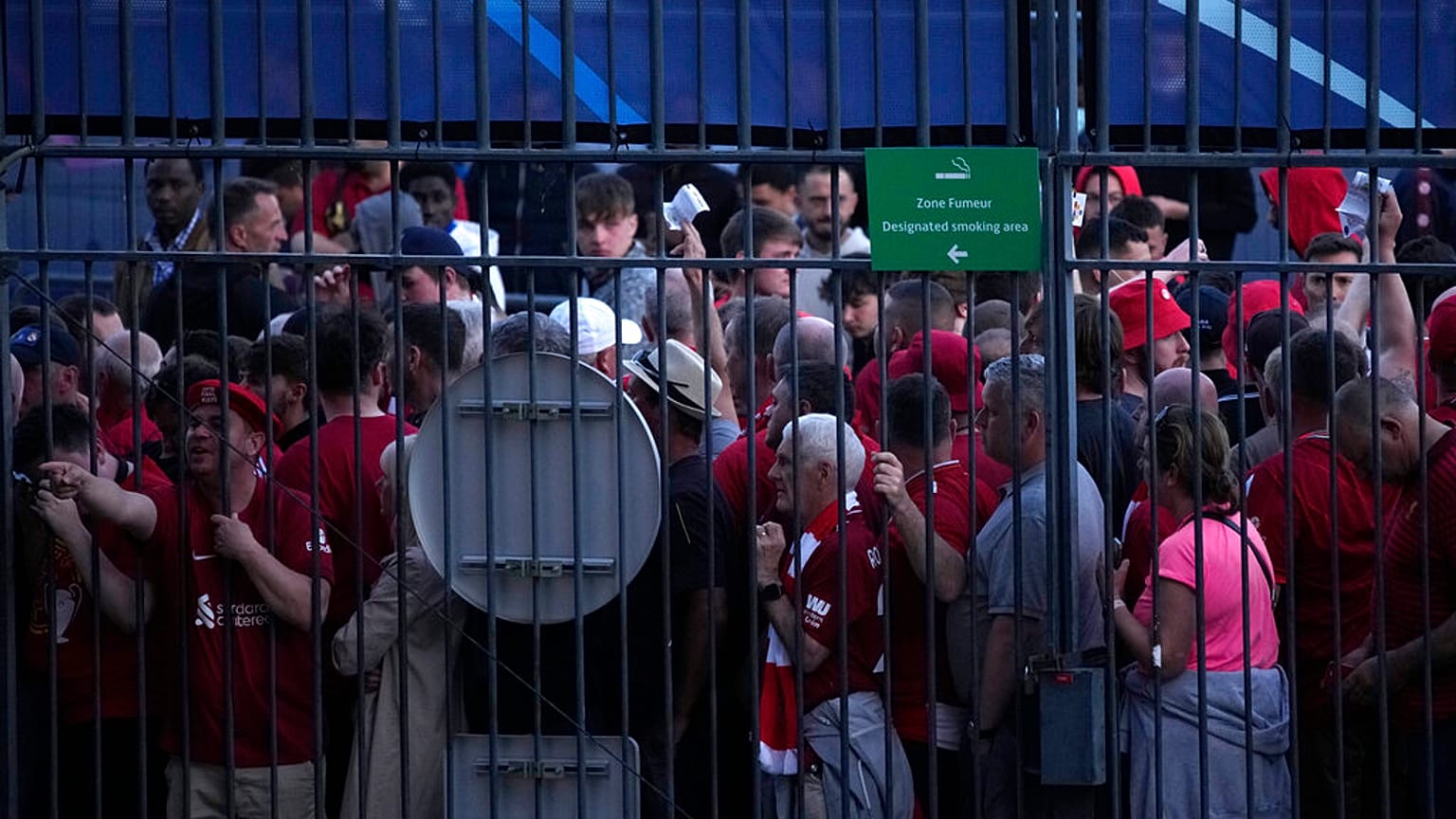 Fans wait in front of the Stade de France prior the Champions League final soccer match between Liverpool and Real Madrid, in Saint Denis near Paris, Saturday, May 28, 2022.