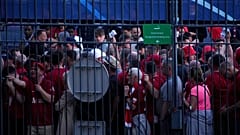 Fans wait in front of the Stade de France prior the Champions League final soccer match between Liverpool and Real Madrid, in Saint Denis near Paris, Saturday, May 28, 2022.