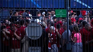 Fans wait in front of the Stade de France prior the Champions League final soccer match between Liverpool and Real Madrid, in Saint Denis near Paris, Saturday, May 28, 2022.