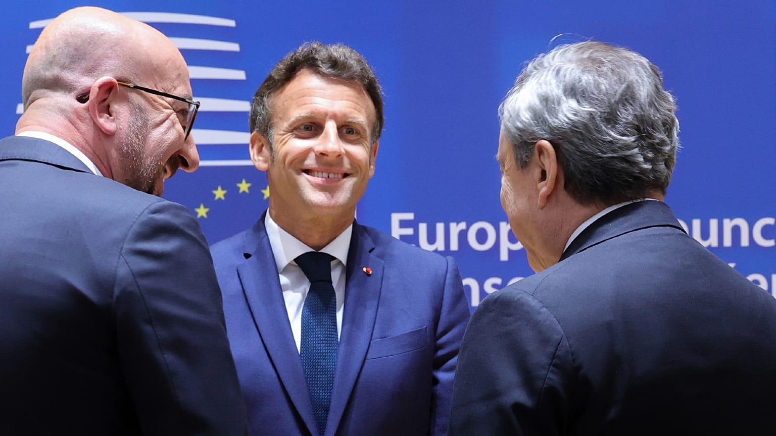 French President Emmanuel Macron (C), EU Council President Charles Michel (L) and Italian Premier Mario Draghi talk at a Council summit in Brussels, May 30, 2022.
