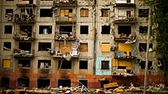 Debris hangs from a residential building heavily damaged in a Russian bombing earlier in the war in Kramatorsk, eastern Ukraine, Saturday, May 21, 2022