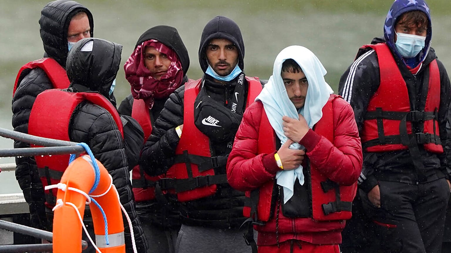 A group of people thought to be migrants are brought in to Dover, Kent, following a small boat incident in the Channel, England, Monday May 23, 2022. 