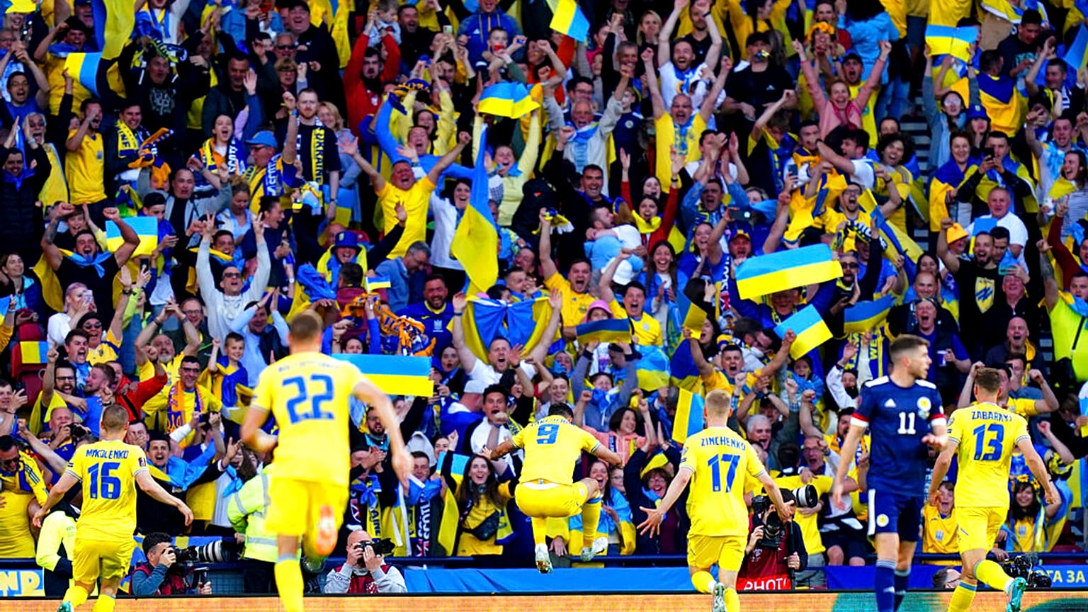 Ukraine's Roman Yaremchuk, center, celebrates after scoring his side's second goal during the World Cup 2022 qualifying play-off soccer match between Scotland and Ukraine. 