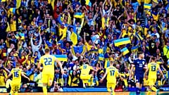 Ukraine's Roman Yaremchuk, center, celebrates after scoring his side's second goal during the World Cup 2022 qualifying play-off soccer match between Scotland and Ukraine. 