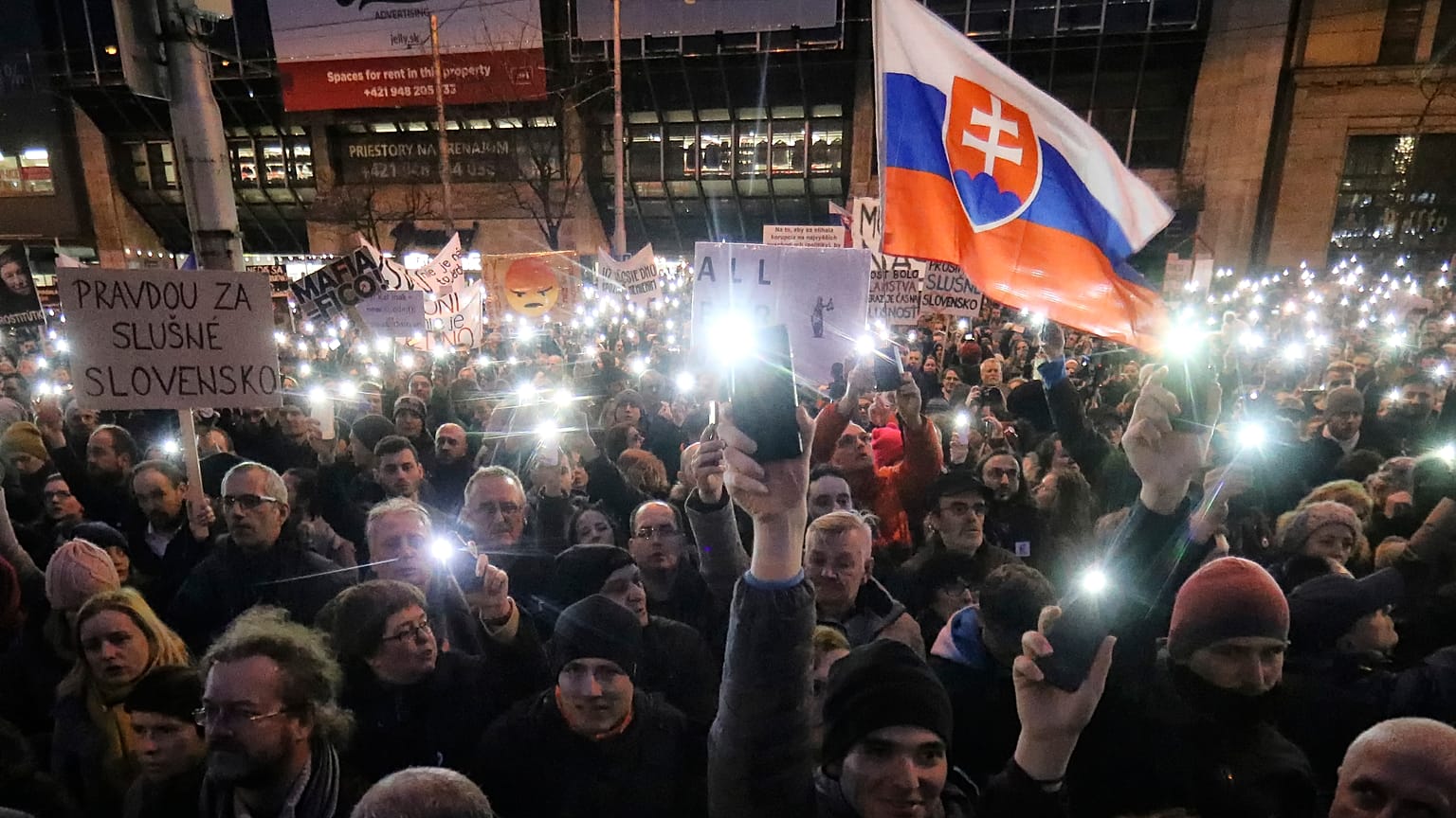 FILE- In this Friday, March 9, 2018, file picture demonstrators light the torches of their smartphones during an anti-government rally in Bratislava, Slovakia. 