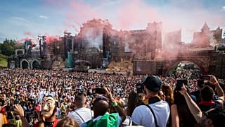 Revelers gather as a DJ performs at the main stage on the first day of the Tomorrowland music festival on July 19, 2019, in Boom.