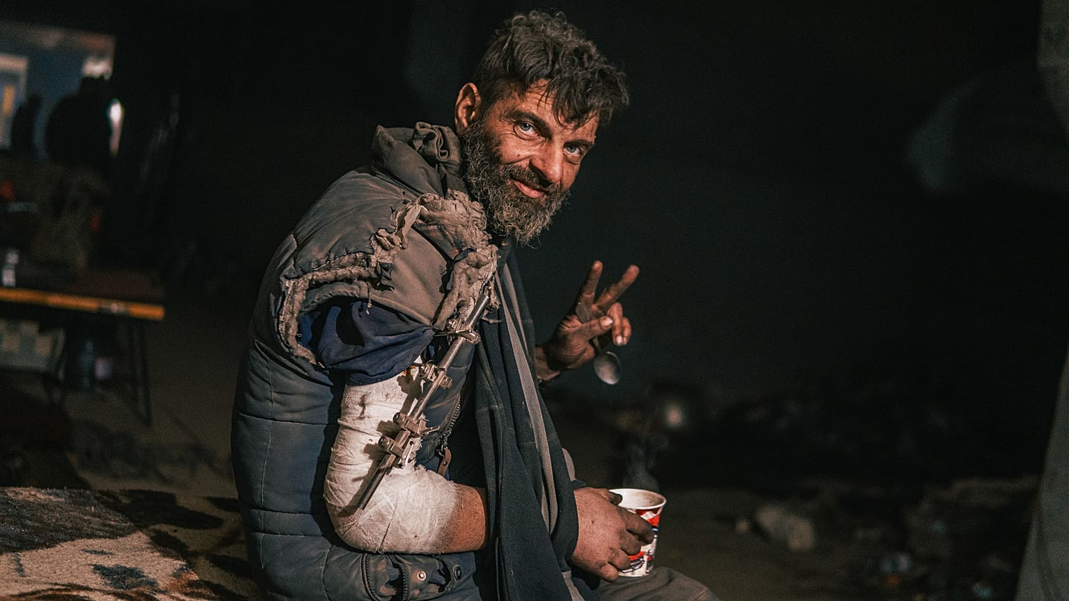 Injured fighter of the Azov regiment receives medical help in a make-shift hospital inside the Azovstal steel plant during its siege, Mariupol, Ukraine. May 2022