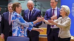 European Commission President Ursula von der Leyen, right, and Denmark's Prime Minister Mette Frederiksen greet each other on Tuesday