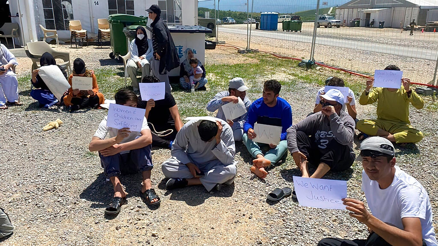 Afghans who fled the Taliban takeover of their country staging a protest at Camp Bondsteel in Kosovo, Wednesday, June 1, 2022. 