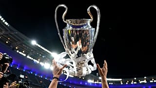 Real Madrid's Luka Modric is reflected in the trophy as he throws it in the air while celebrating with team mates winning the Champions League final in Paris on 29 May 2022