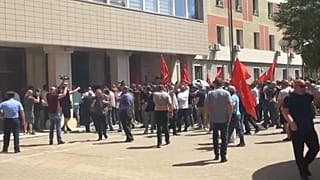 Police say the protesters "tried to enter by force and damage the Parliament building doors".