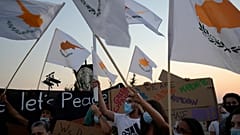 People hold Cyprus flags during a protest against the 47th anniversary of the Turkish invasion on the island, in Dherynia, Cyprus, July 2021