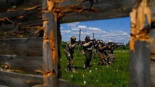 Civilian militia men train at a shooting range in outskirts Kyiv