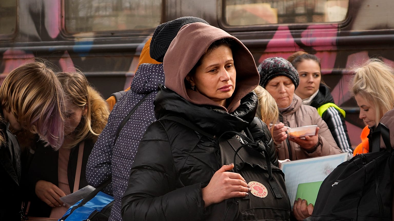 Women, fleeing from Ukraine, stand on a platform at the train station in Przemysl, Poland, Thursday, March 3, 2022