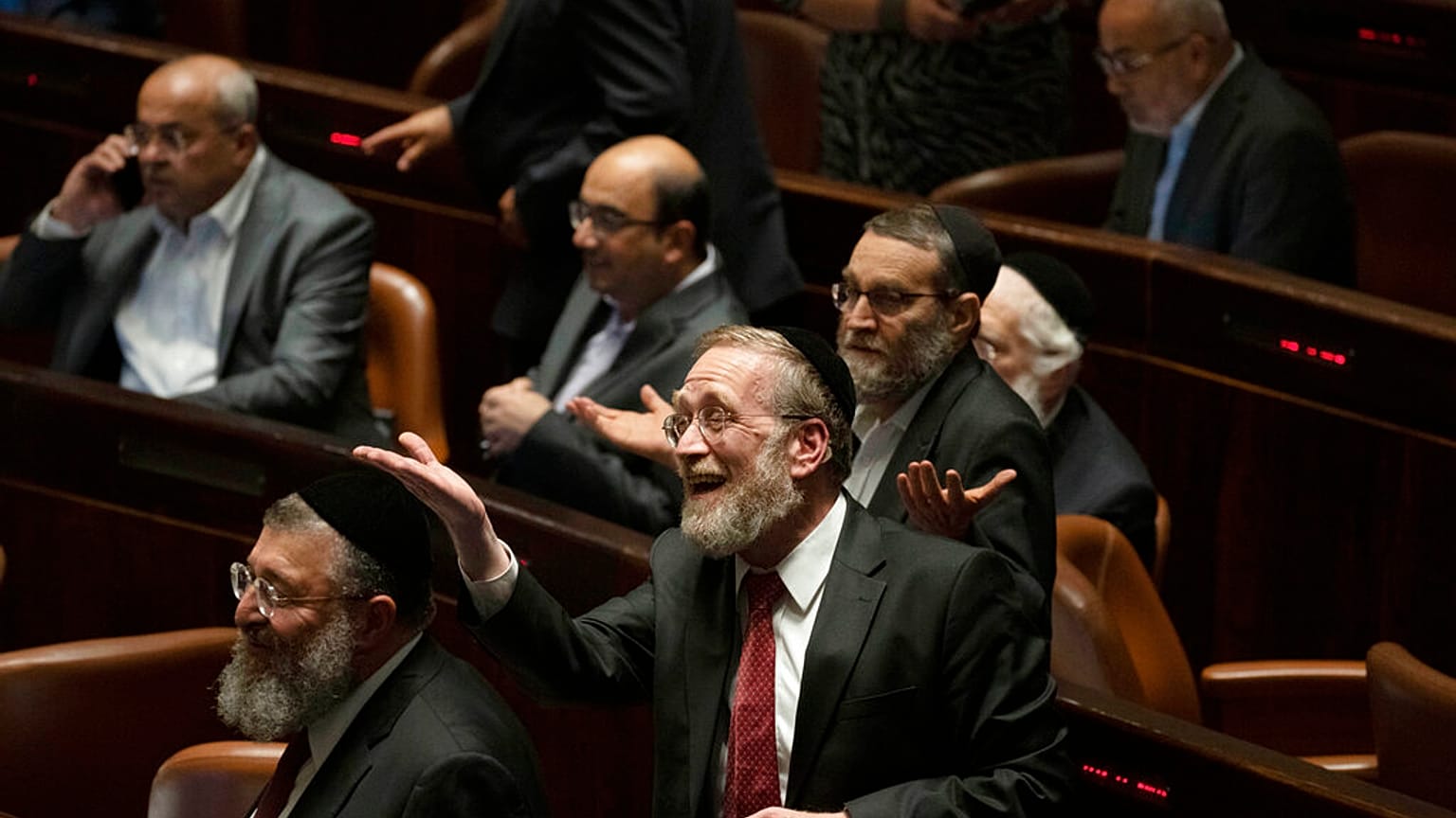 Lawmakers celebrate the defeat of a law on the legal status of Jewish settlers in the occupied West Bank, during a session of the Knesset, Israel's parliament, in Jerusalem