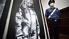 The Banksy mural beside a French official