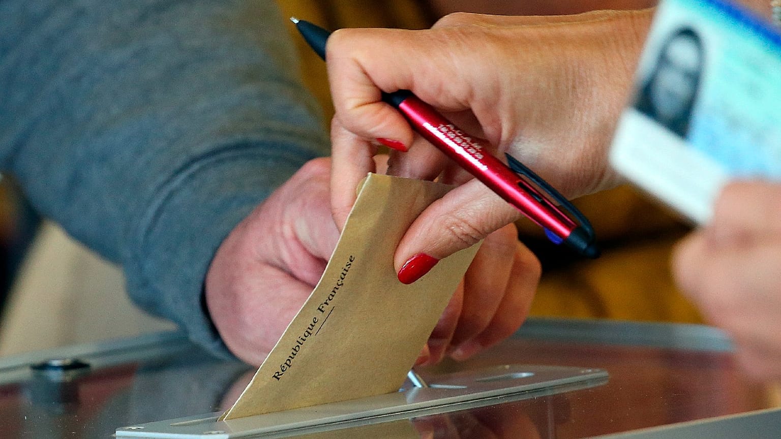 Someone casts a vote at a voting centre during the first round of the municipal elections, in Saint Pee sur Nivelle, southwestern France, March 15, 2020. 
