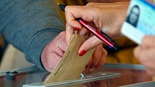Someone casts a vote at a voting centre during the first round of the municipal elections, in Saint Pee sur Nivelle, southwestern France, March 15, 2020. 
