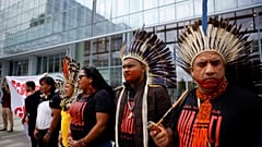 ndigenous groups from the Brazilian Amazon and Extinction Rebellion activists attend a protest in front of Paris courthouse.