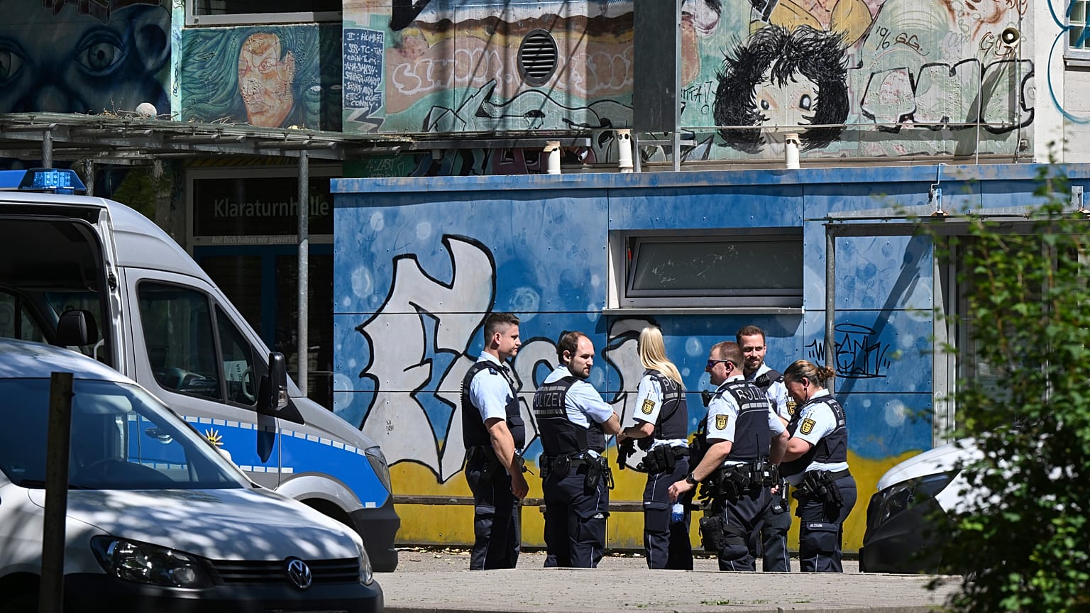 Police officers secure a crime scene in front of a school in Esslingen.