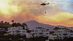 Hubschrauber trägt Wasser in der Nähe von Häusern in Marbella, Malaga (9. Juni 2022)