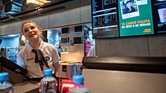 A staff member speaks with visitors at a newly opened fast food restaurant in a former McDonald's outlet in Bolshaya Bronnaya Street in Moscow,, 12 June 2022