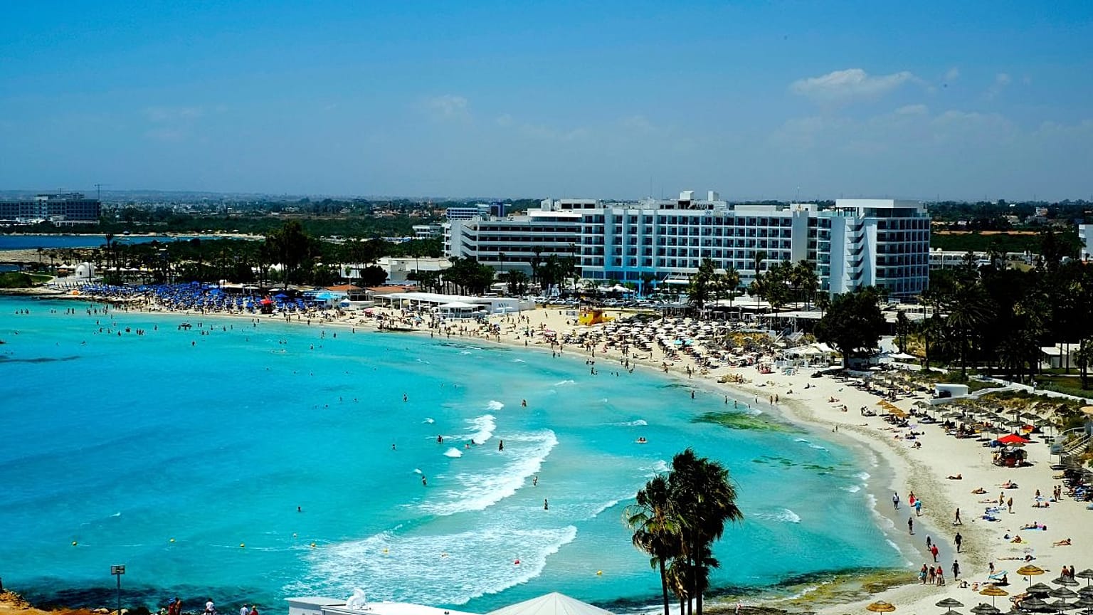 Nissi Beach with people as they enjoy the beach and the sea in southeast resort of Ayia Napa, in the eastern Mediterranean island of Cyprus, Saturday, May 22, 2021