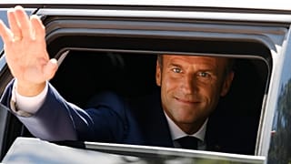 France's President Emmanuel Macron waves as he leaves the polling station after voting in the first round of French parliamentary election on 12 June 2022