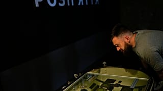 A man looks at objects displayed at "Ukraine Crucifixion" exhibition in Kyiv